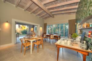 a dining room with wooden tables and chairs at Amberhall Guesthouse in Johannesburg