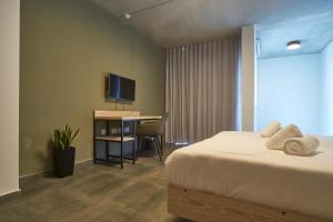a hotel room with a bed and a television at Mr Todd Hotel in Sliema