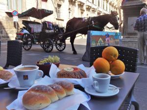 una mesa con café y bollería y un carruaje tirado por caballos en I Vicini della Cattedrale, en Palermo 43 fotos más