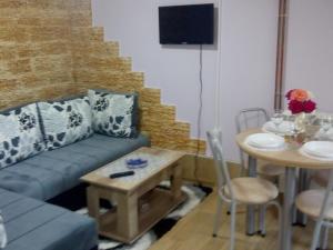 a living room with a couch and a table at Gorica in Vrdnik