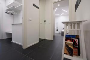a hallway with white walls and a black floor at Galleria 38 in La Spezia
