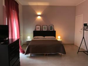 a bedroom with a bed and a tv and a tripod at Apartment Antonella in Ostuni