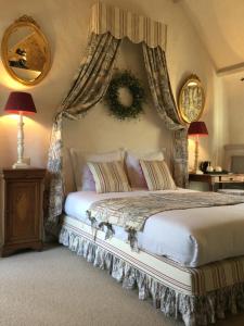 a bedroom with a large bed with two mirrors at B&B Auberge De Klasse in Veurne