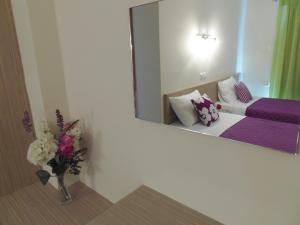 A bed or beds in a room at Angelica Studios and Apartments