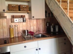 a kitchen with a sink and a counter top at Separate Gästewohnung in Plockhorst +12 photos