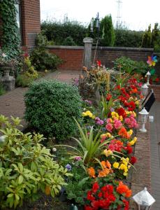 a garden with colorful flowers and plants at Herdshill Guest House in Wishaw