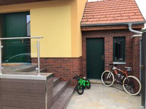 two bikes parked on the side of a house at Vila Pod Zámkem Lednice in Lednice