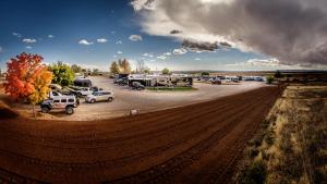 a parking lot with a bunch of vehicles parked at Blue Mountain RV Park in Blanding