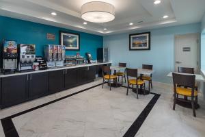 a restaurant with blue walls and tables and chairs at Econo Lodge Inn & Suites Houston NW-Cy-Fair in Houston