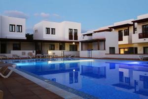 a large swimming pool in front of a building at Casa Zen in Puerto Calero
