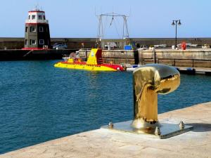 a gold hydrant in a body of water with a boat at Casa Zen in Puerto Calero