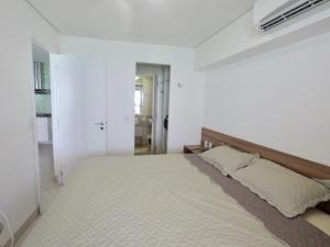 a white bedroom with a large bed in it at Landscape in Fortaleza