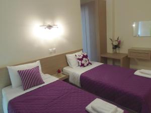 A bed or beds in a room at Angelica Studios and Apartments