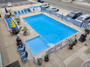 an overhead view of a large swimming pool with chairs at Calypso Boutique Hotel in Wildwood