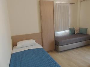 A bed or beds in a room at Angelica Studios and Apartments