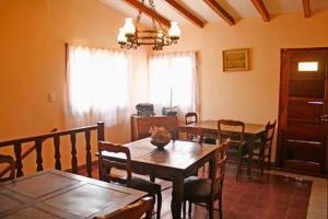 a dining room with a table and chairs and a dining room at Hosteria Nido de Condores in Mina Clavero