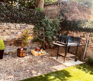 a table and a bench in a garden at Garden Oasis in Margate