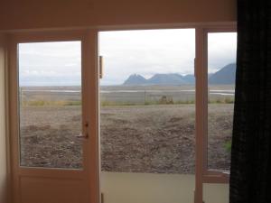 an open door with a view of the desert at Apartment Brekka í Lóni in Stafafell