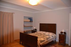 a bedroom with a bed and a chandelier at cascina Filura in Mango