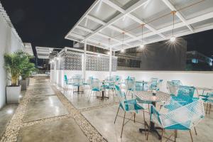 a group of blue chairs and tables on a patio at Casa Mendoza Hotel Boutique in Bucaramanga