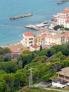 un grupo de casas en una colina junto al océano en Residenza Porta di Mare en Castellabate