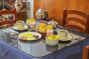 a table with plates of food on a table at Hotel Villa Rita Chiclayo in Chiclayo
