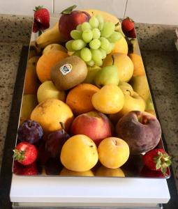 a tray full of fruit on a table at Sorrento Flats in Sorrento