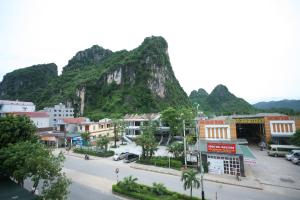 a view of a town with a mountain in the background at Sky Hotel in Phong Nha