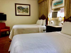
A bed or beds in a room at Casa del Caribe Inn
