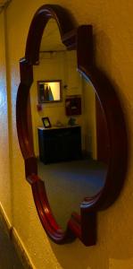a mirror hanging on a wall with a room at Casa del Caribe Inn in San Juan