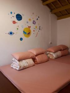 a room with two pillows and planets on the wall at Sky Gift Traditional Farm B&B in Dongshi