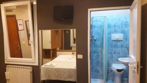 a bathroom with a sink and a toilet and a mirror at Hotel Saint Lorenz in Reggio Emilia