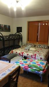 a bedroom with two beds with a blanket on it at romagnoli family cottage in Ameno