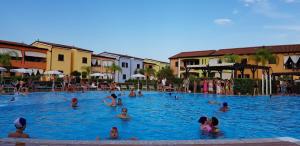 a group of people swimming in a swimming pool at I Giardini Elisei in Policoro