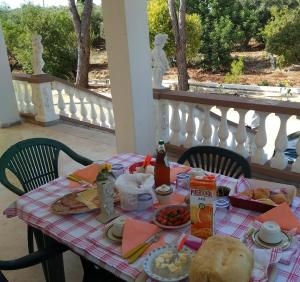 a table with a plate of food on a balcony at Le dimore di Flora Charme in Monopoli