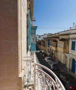 
a building with a train on the tracks next to it at Two Pillows Boutique Hostel in Sliema
