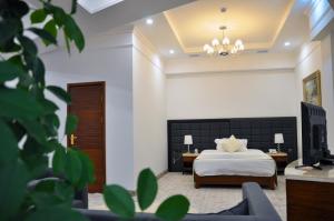 a bedroom with a bed and a couch at Parliament Palace Hotel in Khujand