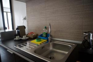 a kitchen counter with a sink in a kitchen at Concept Suites in Alicante +28 photos