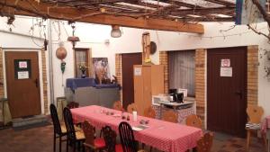 a dining room with a table with a red table cloth at Restaurant Pension Lubusch Gahro in Gahro