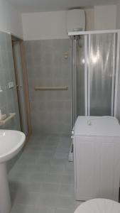 a bathroom with a shower and a toilet and a sink at Casa Vacanza Via Lazio in Torre Lapillo +21 photos