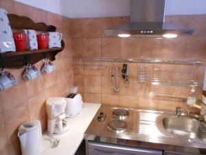 a small kitchen with a sink and a stove at Les Studios de la Madeleine in Avignon