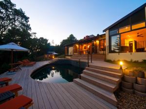a backyard with a swimming pool and a house at Double Dutch B & B in Knysna