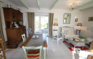 a living room with a table and a dining room at La grange au tracteur in Saulcy-sur-Meurthe
