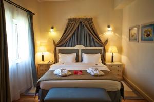 a bedroom with a bed with two stuffed animals on it at Vila Alba Resort in Carvoeiro