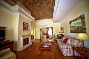 a living room with a couch and a fireplace at Vila Alba Resort in Carvoeiro
