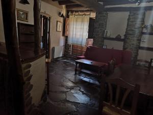 a living room with a couch and a table at Casa Rural La Ortiga in Robledillo de Gata