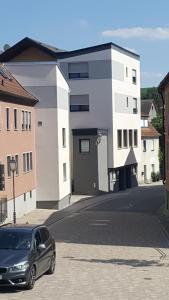 a car parked on a street in front of a building at Hotel & Gästehaus Krone in Geiselwind