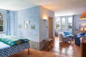 a bedroom with a bed and a living room at Sette Querce in San Casciano dei Bagni