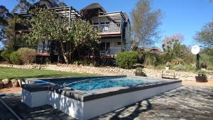 a swimming pool in front of a house at Mountain View Swellendam in Swellendam