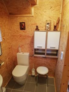 a small bathroom with a toilet and a stool at Ferienhaus FRIEDLHOF in Langschlag